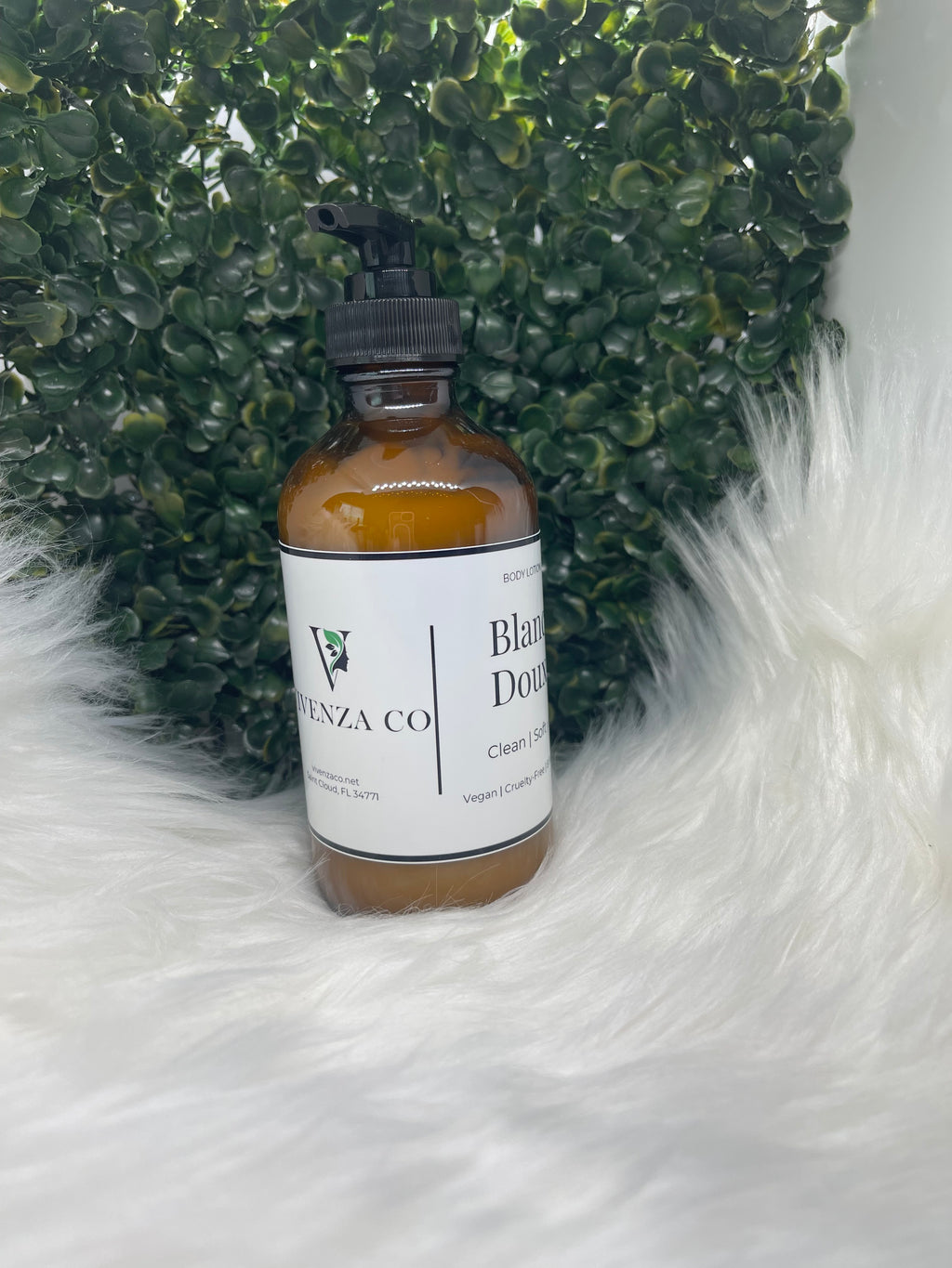 Bottle of VIVENZA Co product on a textured green surface with white fur background