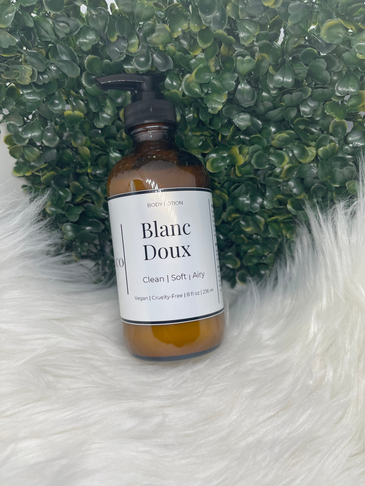 Bottle of 'Blanc Doux' on a textured green and white surface