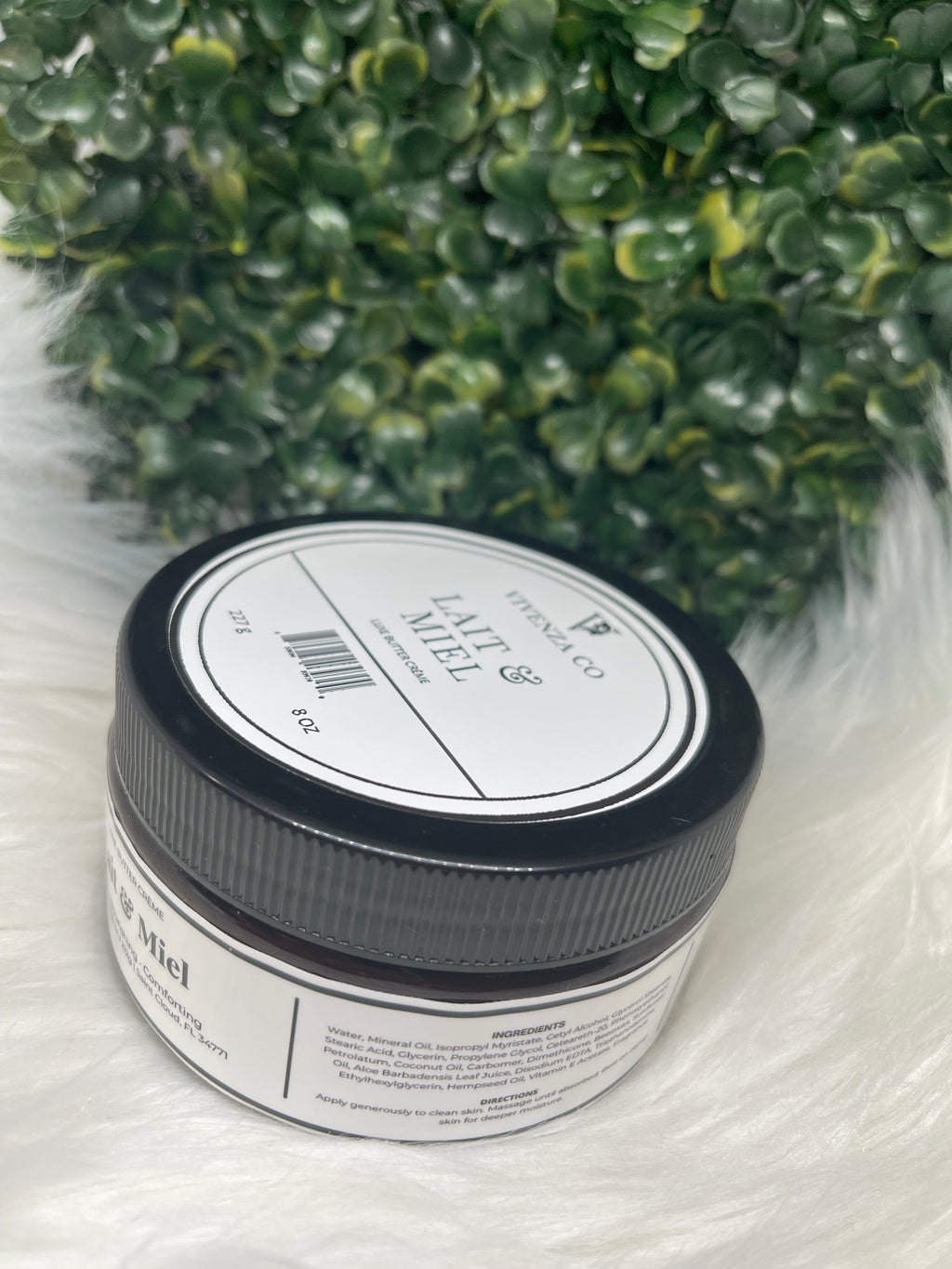 Jar of 'Lait & Miel' cream with a black lid on a white background