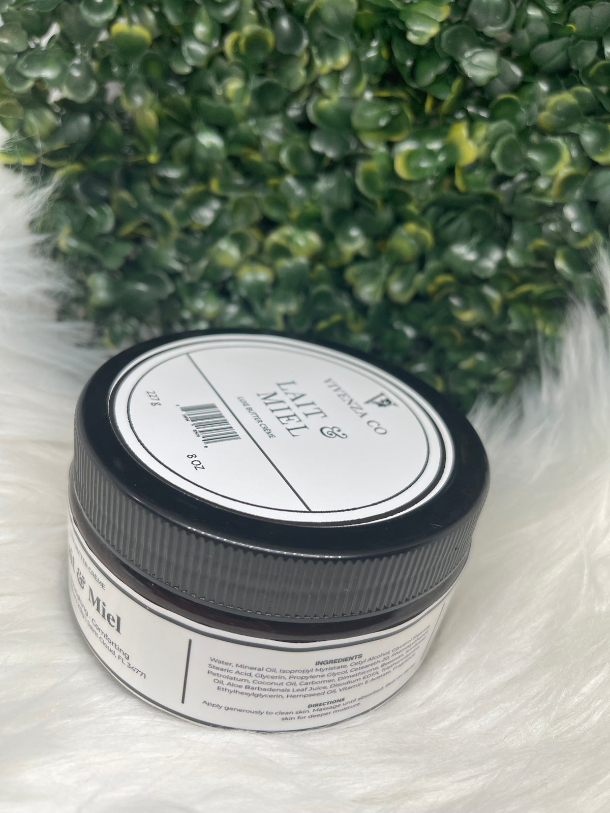 Jar of 'Lait & Miel' cream with a black lid on a white background