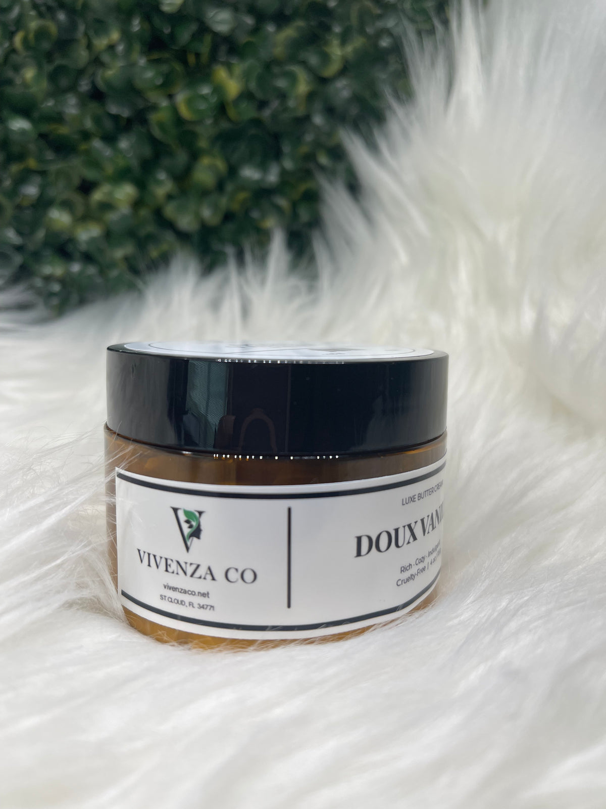Jar of Vivenza Co. product on a fluffy white surface with greenery in the background