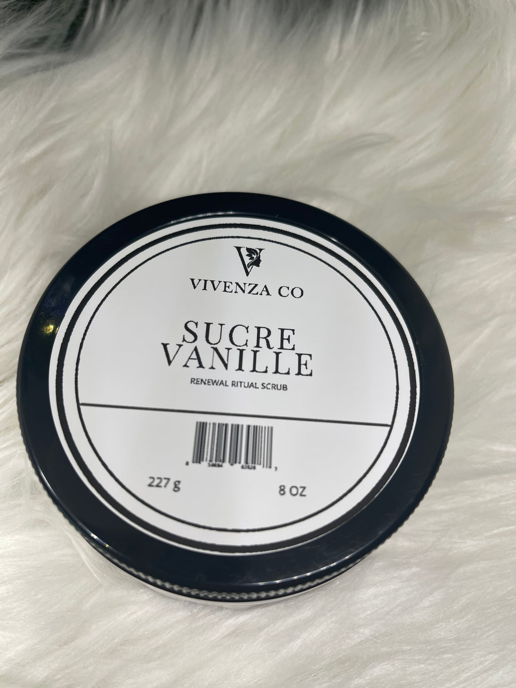 Jar of Vivenza Co. Sucre Vanille body scrub on a fluffy white surface